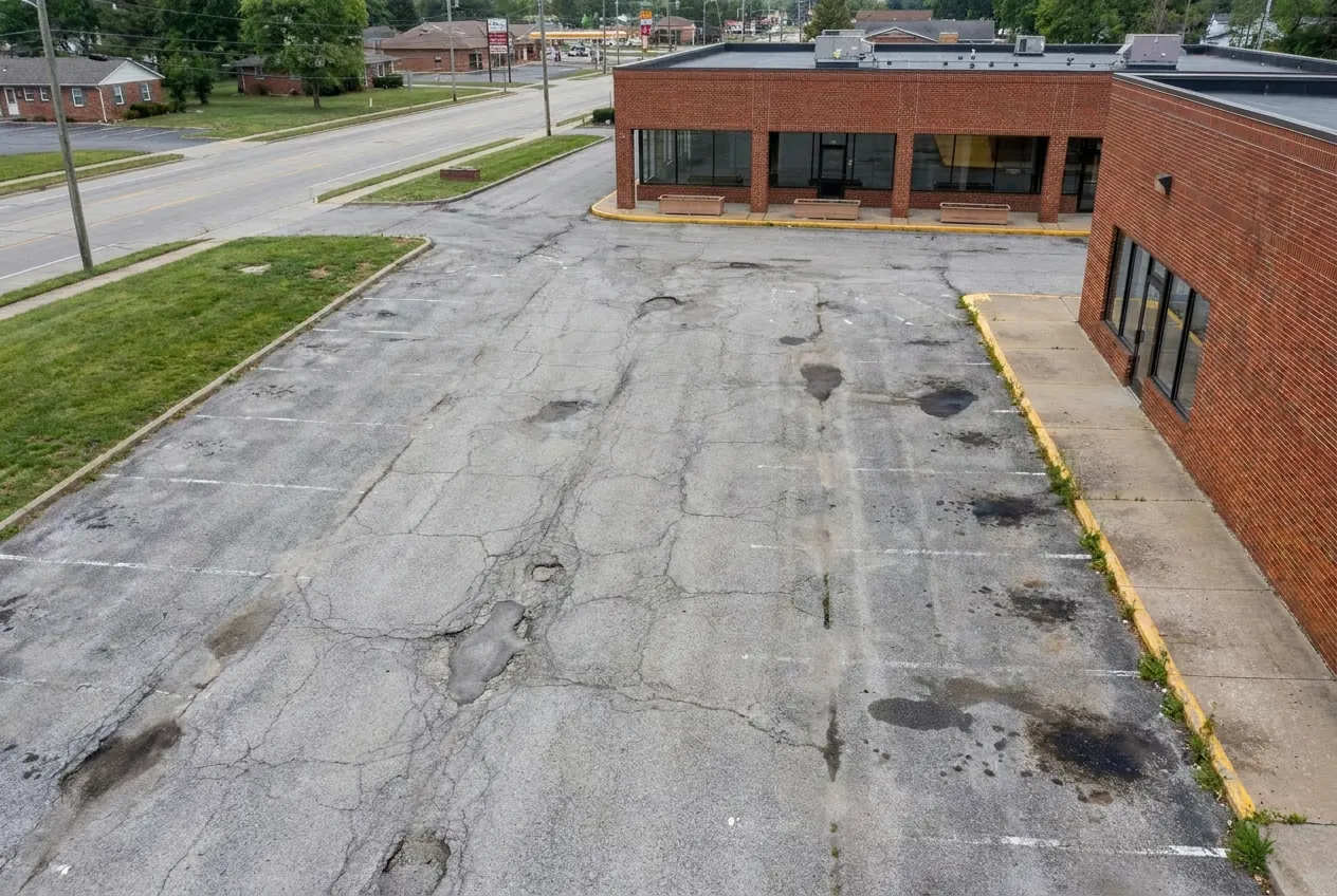 A worn commercial lot before pavement service