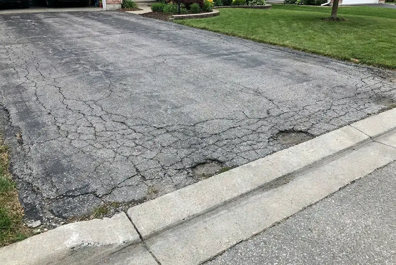 Gray cracked asphalt before sealcoating