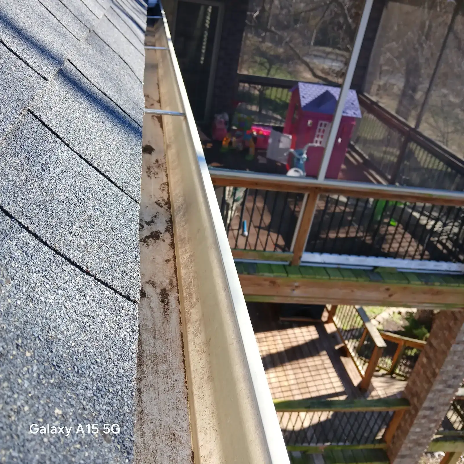 An open gutter packed with leaves and debris