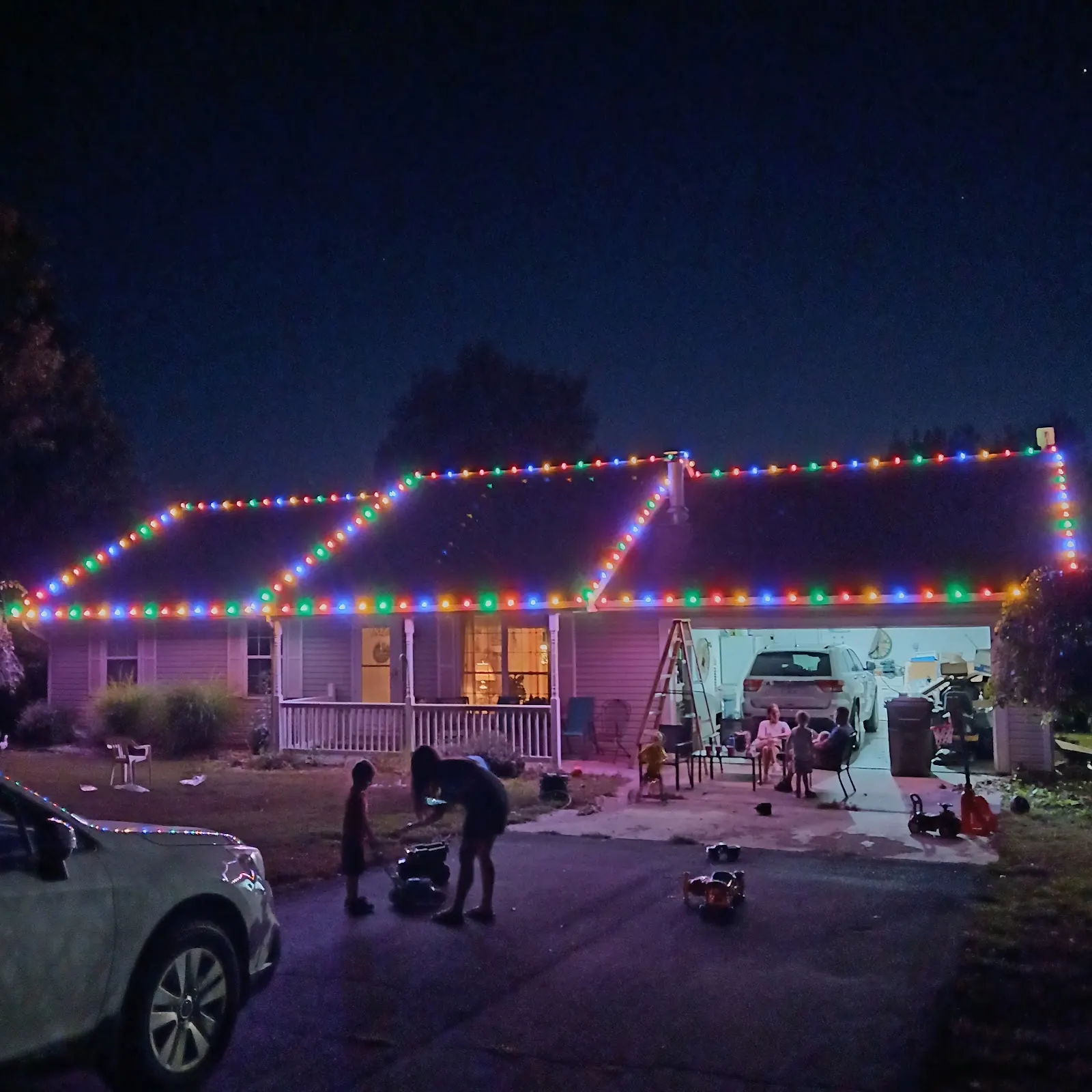 Reliable Pro installing colorful holiday lights at a home