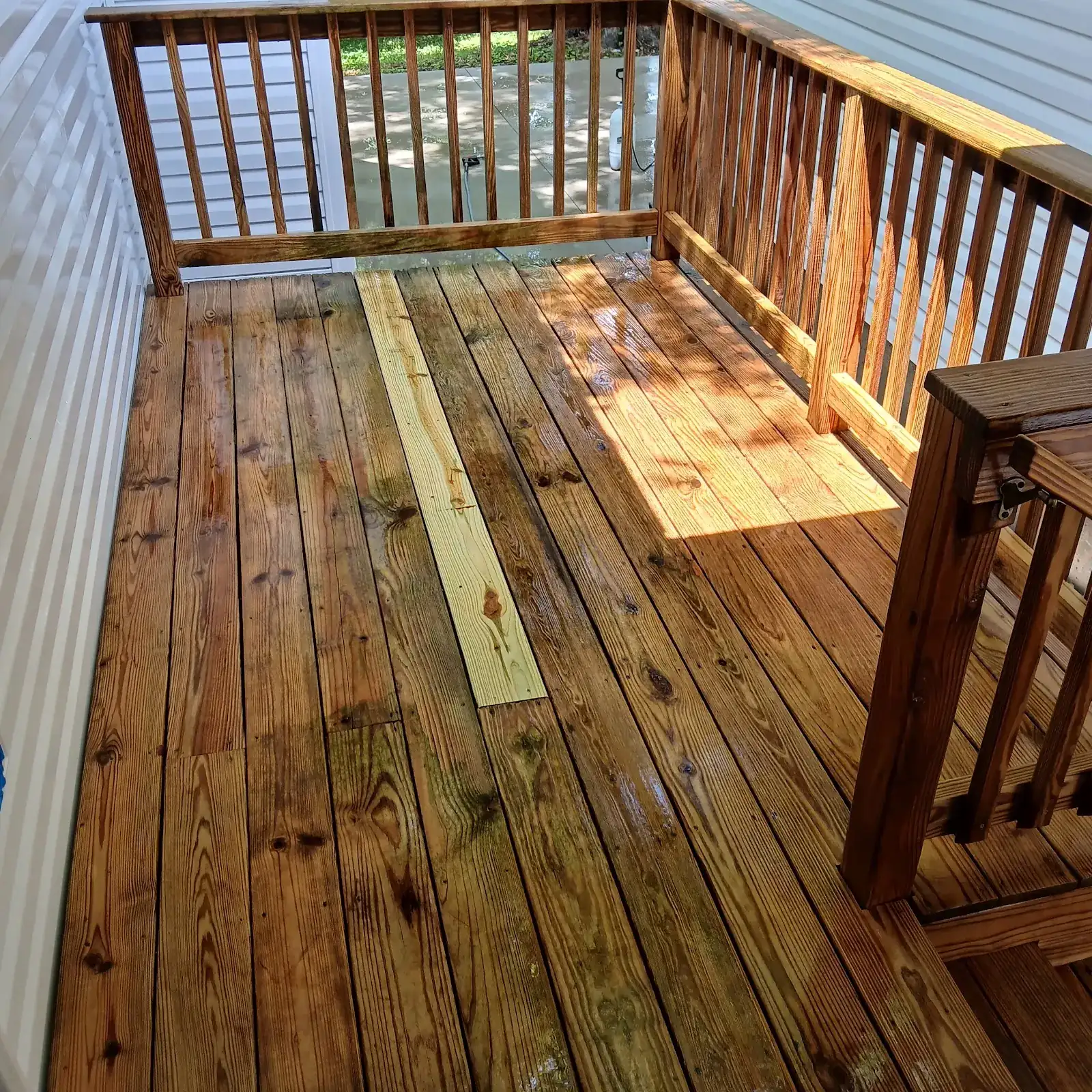 Brightened wood deck after washing