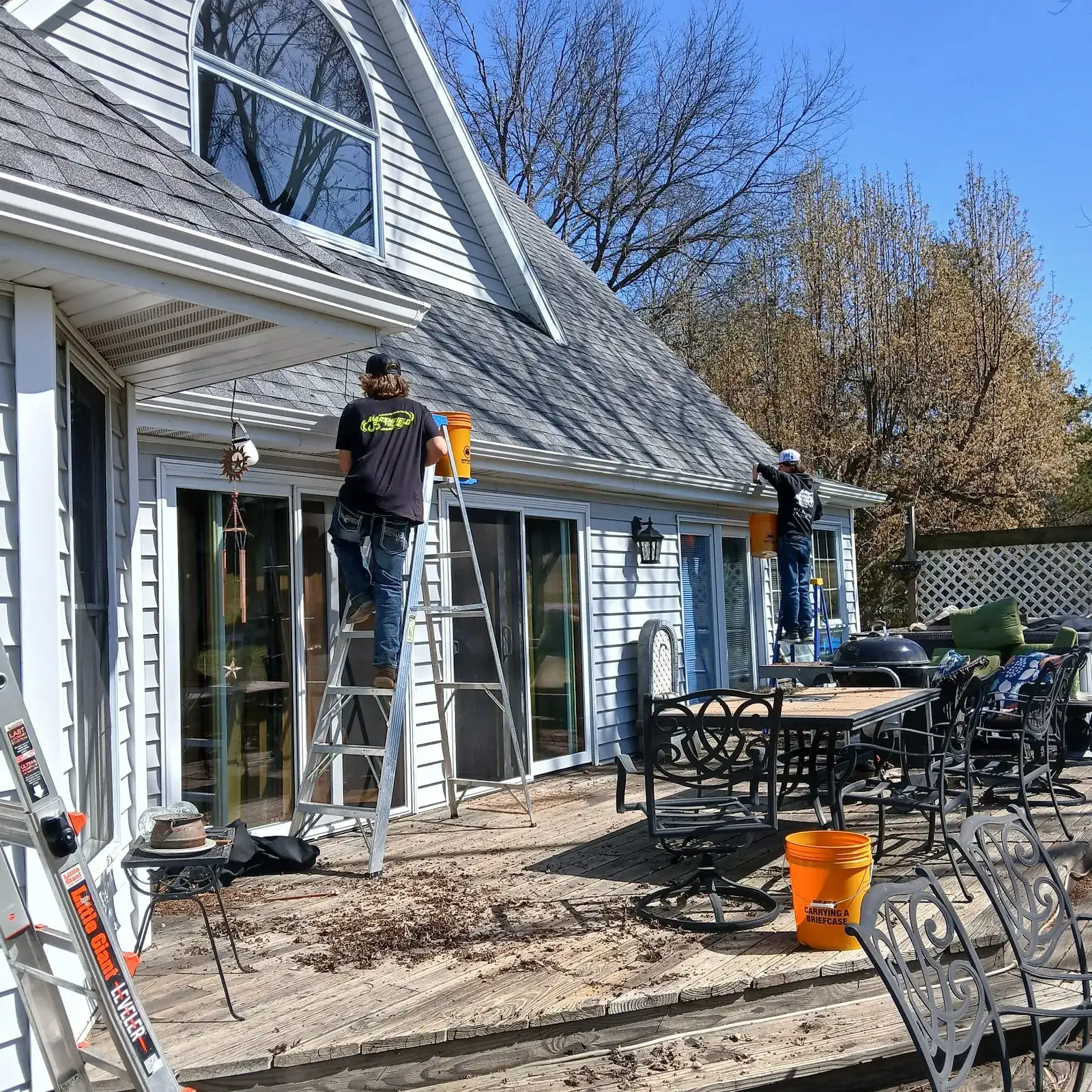 Technician washing a backyard patio